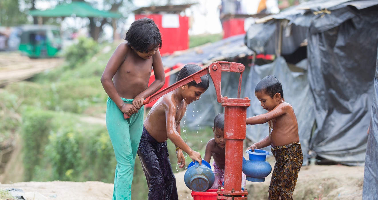 kids washing at a water station